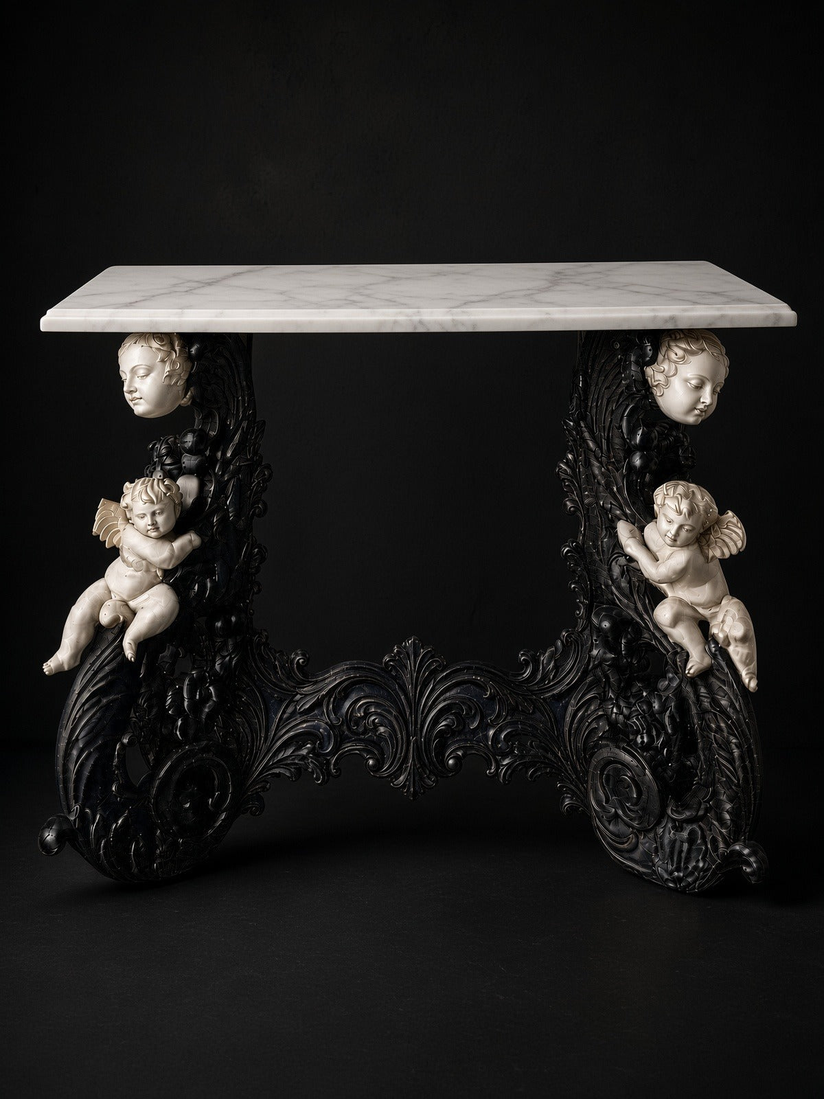 Amorini console with a Carrara top on a black studio ground
