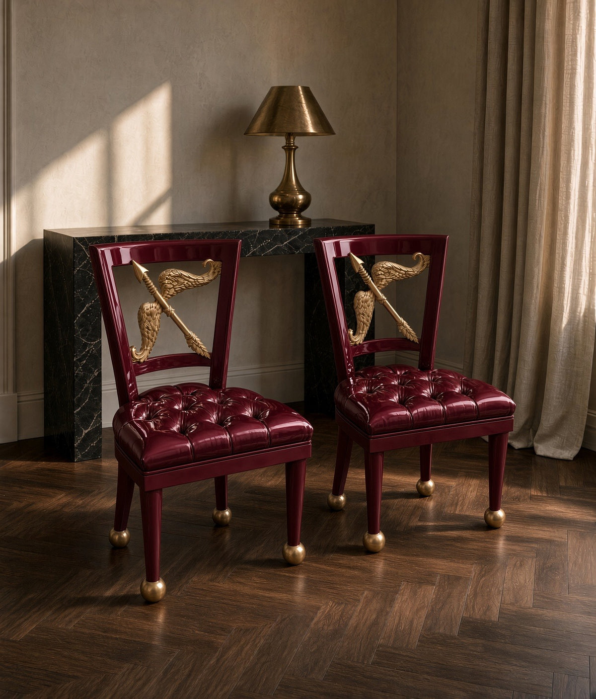 A pair of burgundy Cupid chairs by a marble console
